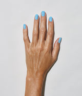 Hand with medium skin tone wearing JINsoon Aero nail polish against a white background