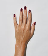 Hand with medium skin tone wearing JINsoon Audacity nail polish against a white background