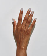 Hand with dark skin tone wearing JINsoon Auspicious nail polish against a white background