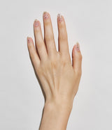 Hand with fair skin tone wearing JINsoon Bijou nail polish against a white background