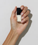 Hand with medium skin tone wearing JINsoon Dew nail polish against a white background