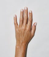 Hand with medium skin tone wearing JINsoon Doux nail polish against a white background