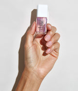 Hand with medium skin tone wearing JINsoon HyperRepair nail treatment against a white background
