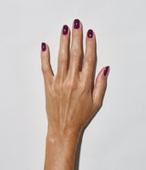Hand with medium skin tone wearing JINsoon Heroine nail polish against a white background
