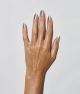 Hand with medium skin tone wearing JINsoon Melange nail polish against a white background