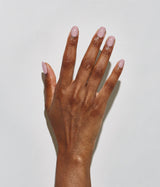 Hand with dark skin tone wearing JINsoon Moxie nail polish against a white background