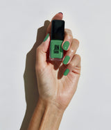 Hand with fair skin tone wearing JINsoon Palma nail polish against a white background