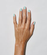 Hand with medium skin tone wearing JINsoon Peace nail polish against a white background