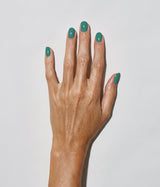 Hand with medium skin tone wearing JINsoon Scuba nail polish against a white background