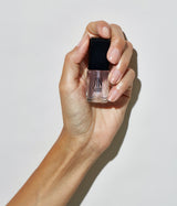 Hand with medium skin tone wearing JINsoon Top Gloss top coat against a white background