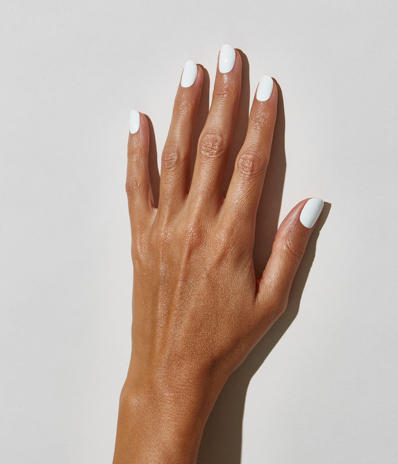 Hand model with JINsoon Absolute White against a white background (mid skin tone).