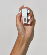 Hand model with JINsoon Absolute White against a white background (mid skin tone).