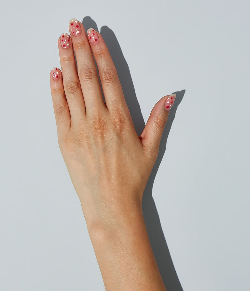 Nail art design with JINsoon Muse as the base color, adorned with dotted patterns using Absolute White and Sinopia.