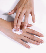 Model gently applying hand cream.
