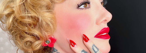 blonde model with red lipstick posing her red nails 