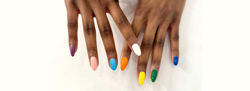 darked-skin hands with colorful nails featuring purple, soft pink, sky blue, white, sunset orange, bright yellow, palma green and electric blue