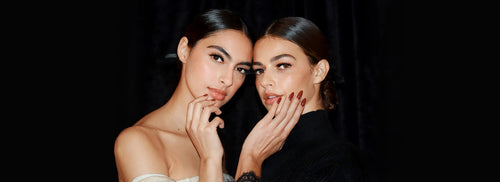 Two women showing their nails.