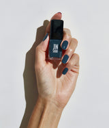 Hand with fair skin tone wearing JINsoon Abyss nail polish against a white background