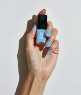 Hand with fair skin tone wearing JINsoon Aero nail polish against a white background