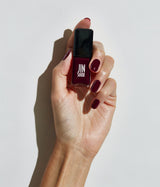 Hand with fair skin tone wearing JINsoon Audacity nail polish against a white background
