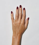 Hand with medium skin tone wearing JINsoon Audacity nail polish against a white background