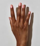 Hand model with JINsoon Aura against a white background (Deep skin tone).