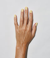 Hand with medium skin tone wearing JINsoon Chillin nail polish against a white background