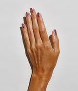 Hand with dark skin tone wearing JINsoon Glee nail polish against a white background