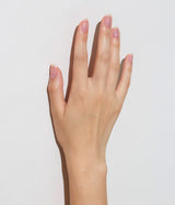 Hand with light skin tone wearing JINsoon HyperRepair nail treatment against a white background