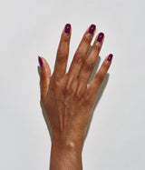 Hand with dark skin tone wearing JINsoon Heroine nail polish against a white background