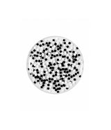 A round clear swatch filled with small black and white square confetti