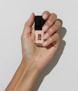 Hand with medium skin tone wearing JINsoon Muse nail polish against a white background