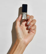 Hand with medium skin tone wearing JINsoon Nifty nail polish against a white background
