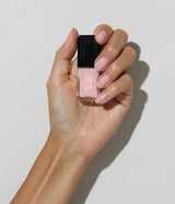 Hand with medium skin tone wearing JINsoon Pixie nail polish against a white background