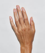 Hand with medium skin tone wearing JINsoon Power Coat base coat against a white background