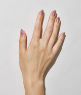 Hand with fair skin tone wearing JINsoon Shake It nail polish against a white background