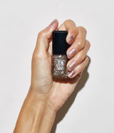 Hand with medium skin tone wearing JINsoon Shake It nail polish against a white background