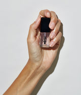 Hand with medium skin tone wearing JINsoon Top Gloss top coat against a white background