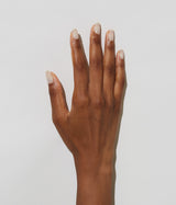 Hand with dark skin tone wearing JINsoon Tulle nail polish against a white background