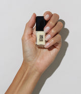 Hand with medium skin tone wearing JINsoon Tulle nail polish against a white background