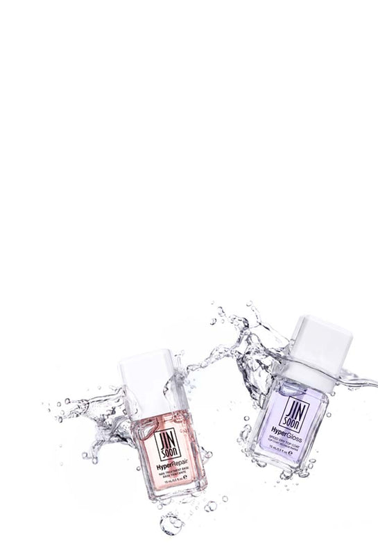 Two nail polish bottles with water splashes on a white background
