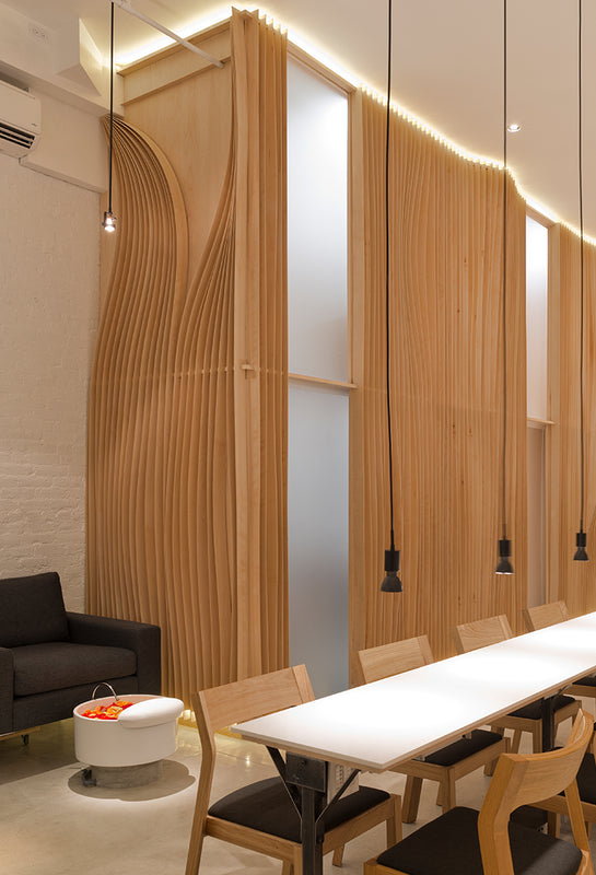 Modern interior design with long white table and chairs in a well-lit room.